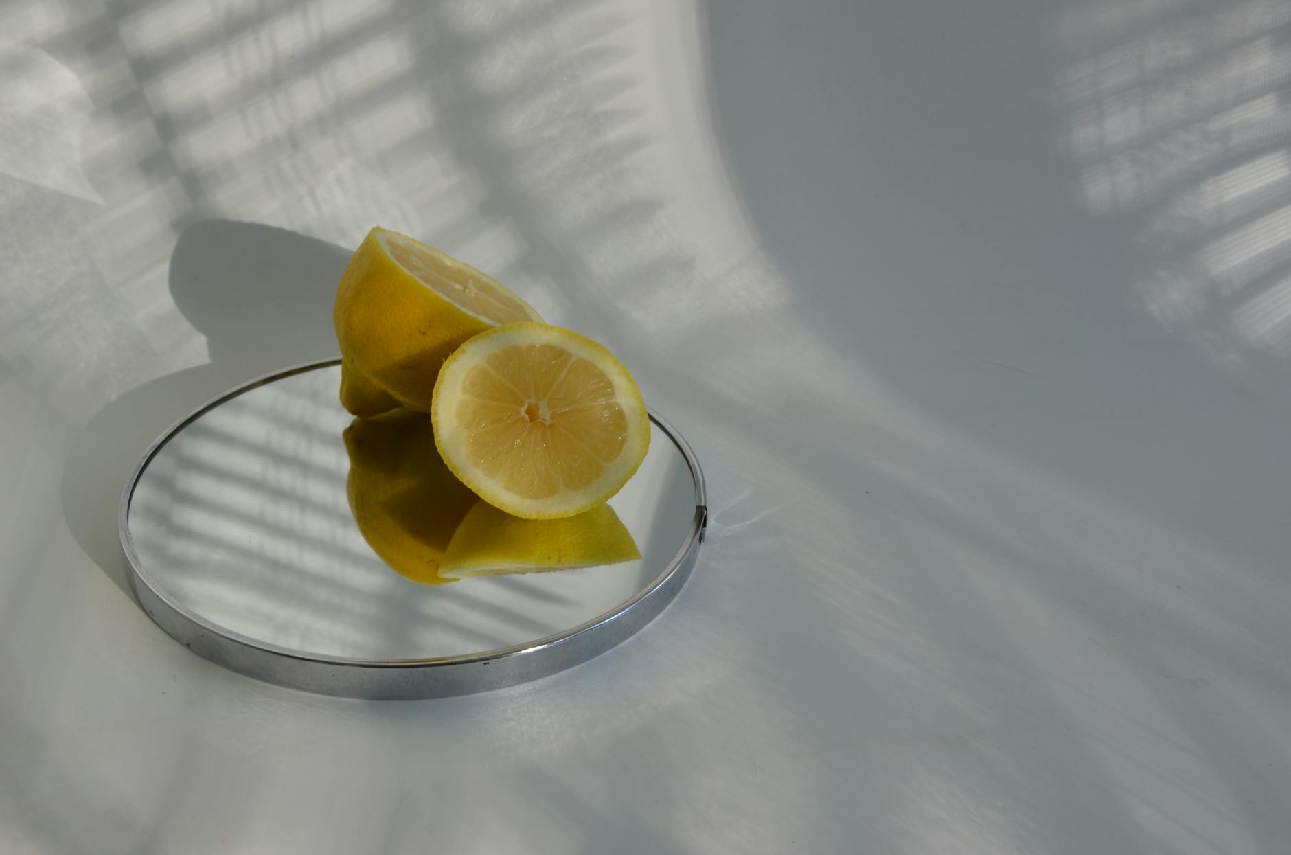 A hand holding a blue vibrator above a decorative glass bowl, representing modern pleasure tools and intentional self-care