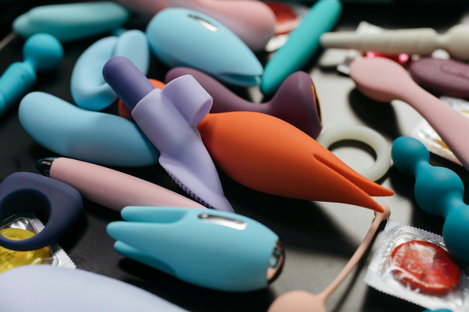 Close-up array of colorful vibrators and intimate wellness toys displayed together